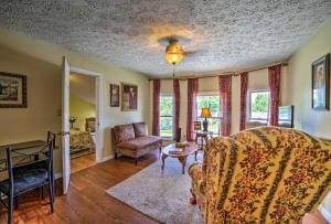 a living room with a couch and a table at Explore Lake Erie and Strip From Quaint Apartment! in Geneva-on-the-Lake