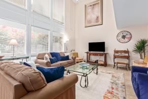 a living room with two couches and a tv at Desert Rose Villas - Spotless Three Bedroom Villa in the Heart of Scottsdale in Scottsdale