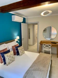 a bedroom with a large bed with a blue wall at L'EMPORIO ROOMS in Manarola