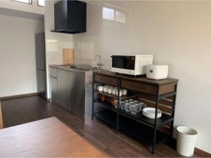 a kitchen with a counter with a microwave on it at Halettohouse SAKANOSHITA - Vacation STAY 30106v in Kamakura