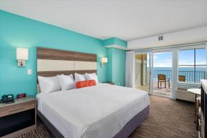 a bedroom with a large bed and a large window at Monte Carlo Boardwalk / Oceanfront Ocean City in Ocean City