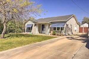 a white house with a blue roof and a driveway at 2 Mi to Dtwn Phoenix Cottage with Private Yard! in Phoenix