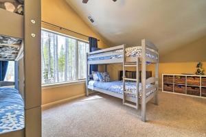 a bedroom with two bunk beds and a window at Great for Groups Soda Springs Cabin with Deck! in Soda Springs