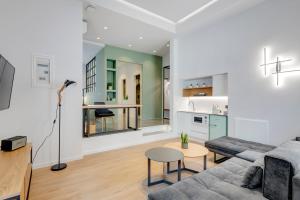 a living room with a couch and a table at Times Elegant Rooms in Ermoupoli