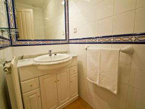 a bathroom with a sink and a mirror at Apartamento EL RINCON DE MARIA in Santillana del Mar