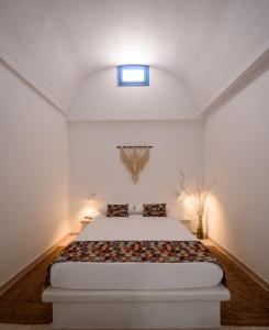 a bedroom with a large bed in a room at Cal Day Rooms Santorini in Perissa