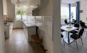 a kitchen with a table and chairs and a counter top at Rybitwa Karwia in Karwia