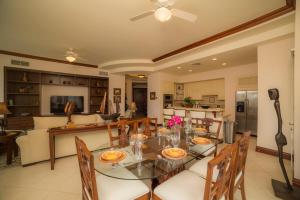 a dining room and living room with a table and chairs at 3 bedroom Bella Vista 2D close to pool by Stay in CR in Herradura