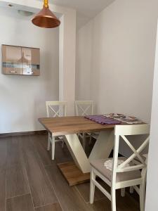 a dining room with a wooden table and chairs at Apartmani Vila in Cetinje