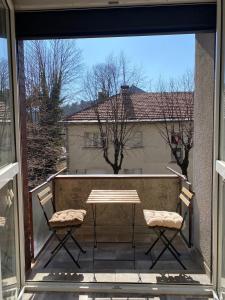 a patio with a table and two chairs on a balcony at Apartmani Vila in Cetinje