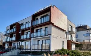 a building with balconies on the side of it at Apartament Turkus Mechelinki in Mechelinki