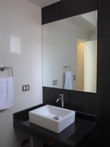 a bathroom with a white sink and a mirror at Spacious Apartment in Miraflores in Lima +22 photos