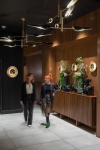 two people walking down a hallway in a building at Hotel Stratford in San Francisco