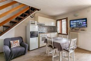 a kitchen and dining room with a table and chairs at Casa con terrazzo vista Lago - LAKEHOLIDAY IT in Castel di Tora