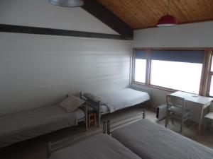 מיטה או מיטות בחדר ב-Gjesteheim Havdal