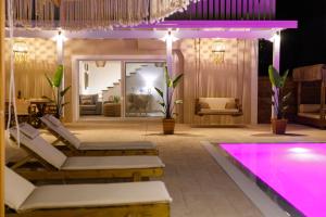 een kamer met een zwembad en een spa met paarse lichten bij Zante Oceana in Tsilivi