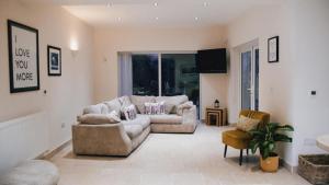 een woonkamer met 2 banken en een tv bij "Rosecroft" - Perfect Retreat for Business & Leisure - Close to Celtic Manor and ICC in Newport