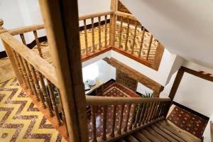 an overhead view of a wooden staircase in a house at La Casa del Orfebre in Cuenca