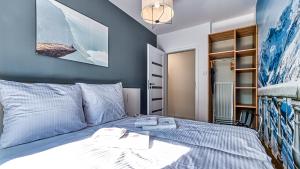 a bedroom with a bed with two towels on it at Apartament przy Wyciągu 2 - 5D Apartamenty in Świeradów-Zdrój