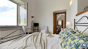 a bedroom with a bed and a window at The Hidden Garden in Ravello