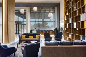 a living room with couches and a large library at Radisson Blu Hotel Antananarivo Waterfront in Antananarivo