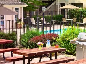 a picnic table with flowers on it next to a pool at Sonesta ES Suites Chicago - Schaumburg in Schaumburg