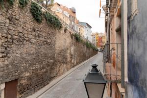 an alley with a street light next to a building at La Casa del Orfebre in Cuenca +127 photos