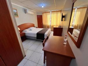 Postel nebo postele na pokoji v ubytování Grand Hotel Machala