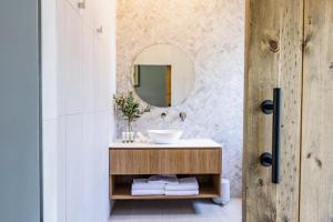a bathroom with a sink and a mirror at Camden Valley Inn in Camden