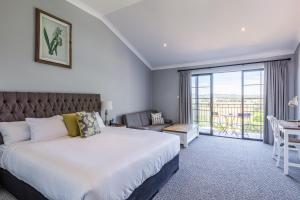 a bedroom with a large bed and a balcony at Camden Valley Inn in Camden +47 photos
