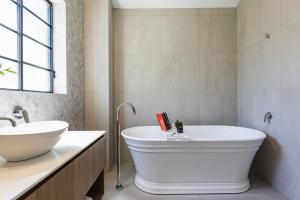 a bathroom with a large tub and a sink at Camden Valley Inn in Camden