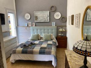 a bedroom with a bed with a plaid blanket at La Casa Rural de Carlos in Playa de Gandia