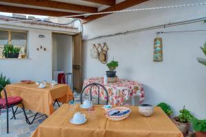two tables in a room with two chairs and a table at Daphne B&B in San Vito lo Capo