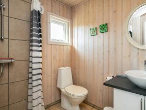 a bathroom with a toilet and a sink at 8 person holiday home in Brovst-By Traum in Brovst +32 photos