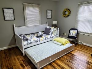 a bedroom with a bed and a chair at Beautiful, Modern & Convenient Home in Quinton, VA in Quinton