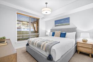a bedroom with a bed and a window at Spring Creek Vacations in Canmore