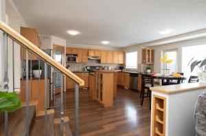 a large kitchen with wooden cabinets and a table at Elegant 6 Bedroom House Near U of Manitoba in Winnipeg