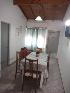a dining room with a table and some chairs at LA CASA DEL MAR in Santa Clara del Mar