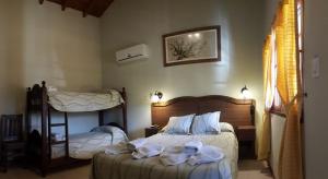 a bedroom with two beds with towels on them at DEL INFINITO in Capilla del Monte +63 photos