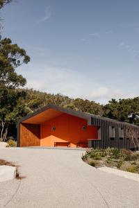 a house with an orange and black facade at Iron Creek Bay Estate in Sorell