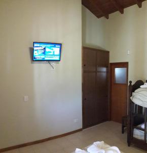 a flat screen tv on a wall in a room at DEL INFINITO in Capilla del Monte