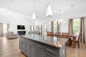 a kitchen and living room with a large counter top at Shore Enough in Destin