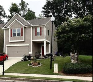 a house with a car parked in the driveway at Charles Emihe in Newnan