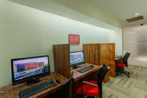 a room with three computer monitors on a desk at Camino Real Aeropuerto in Mexico City