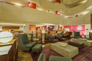 a lobby of a hotel with chairs and tables at Camino Real Aeropuerto in Mexico City