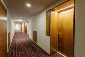 a corridor of a hotel room with a hallway with a door at Camino Real Aeropuerto in Mexico City