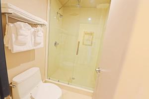 a bathroom with a shower and a toilet at Crescent Bay Inn in Laguna Beach