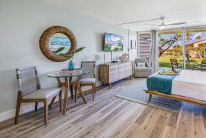 a bedroom with a bed and a table and chairs at Napili Shores G154 Ocean View Studio condo in Kahana
