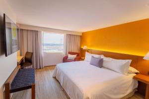 a hotel room with a large bed and a window at Camino Real Aeropuerto in Mexico City