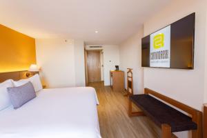 a hotel room with a bed and a sign on the wall at Camino Real Aeropuerto in Mexico City